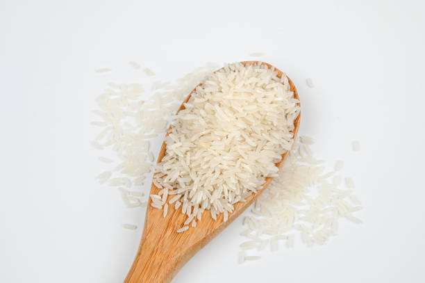 istock Raw white rice in a wooden spoon on white 1481168619