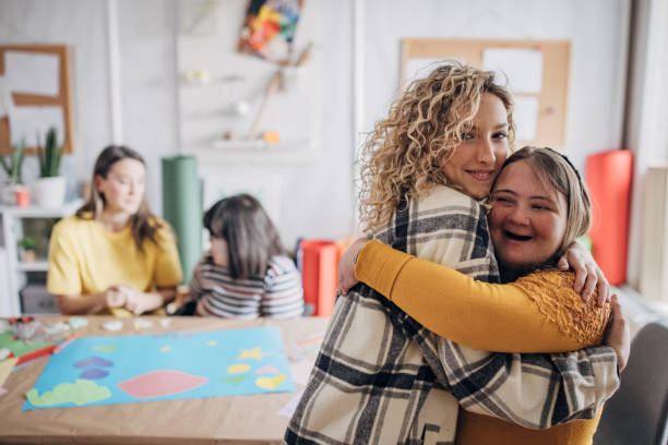 istock Group of people with Down syndrome hugging at the community centre 1481168765