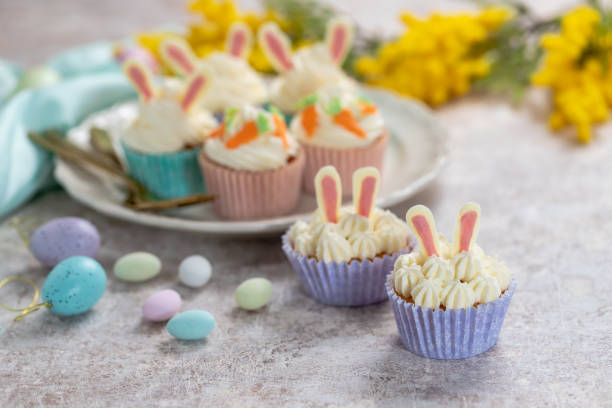 istock Easter cupcake with cream cheese frosting decorated with carrots and bunny ears. 1481171849