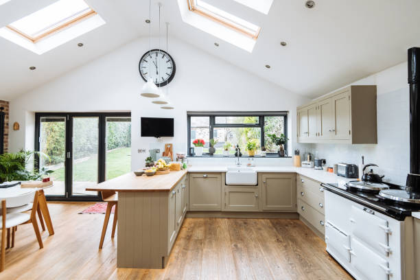 istock Modern kitchen with roof windows, kitchen island and glass doors 1481175437