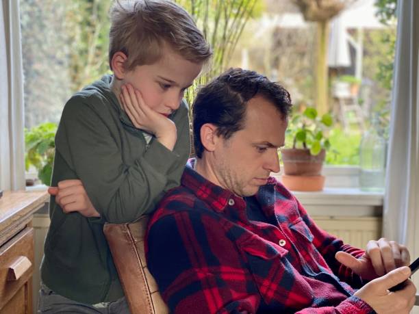 istock Father and son chatting on smartphone 1481175846