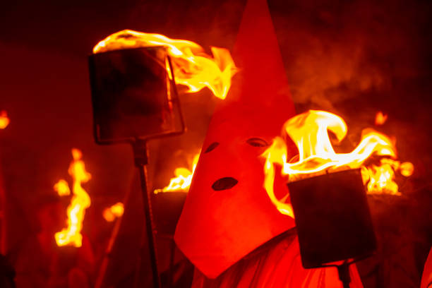 Goias, Goias, Brazil – April 06, 2023:  Close-up of a farricoco, holding a torch with fire, in the Fogareu procession, a typical festival in the city of Goiás in Brazil.