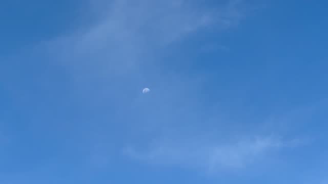 Little moon against blue sky