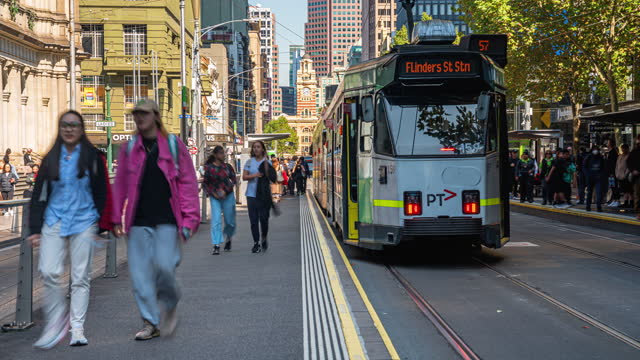 Time Lapse of Crowded Commuter and Tourist walking and crossing road at Flinders Street Railway Station around Bourke Street and Elizabeth Street in Melbourne City, Victoria, Australia