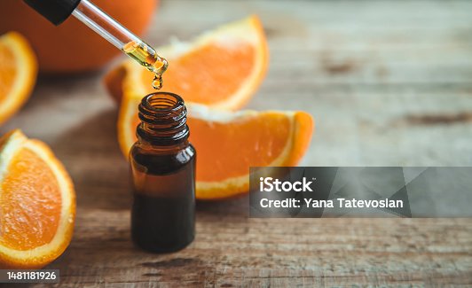 istock Orange essential oil in a small bottle. Selective focus. 1481181926