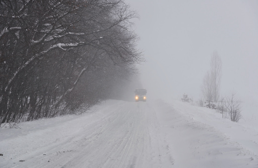 Country road in winter during snowstorm. Kyiv outskirts, Ukraine