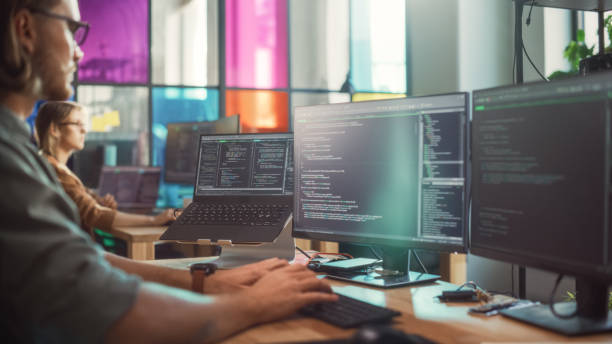 istock Professional Male Data Scientist Writing Code on Desktop Computer in Stylish Coworking Office Space. Caucasian Man Using Software to Analyze Information From Internet and Improve Performance. 1481183512
