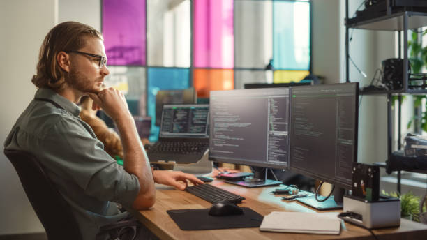 istock Professional Male Data Scientist Writing Code on Desktop Computer in Stylish Coworking Office Space. Caucasian Man Using Software to Analyze Information From Internet and Improve Performance. 1481183539