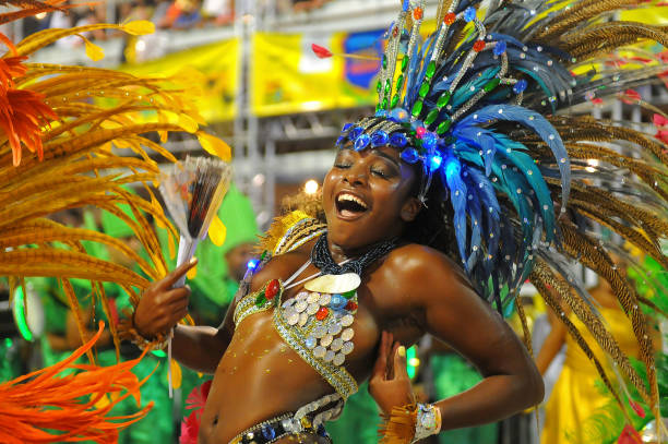 beautiful brazilian carnival samba dancer smiling while partying on parade; porto alegre, rio grande do sul, brazil - sambadrome imagens e fotografias de stock