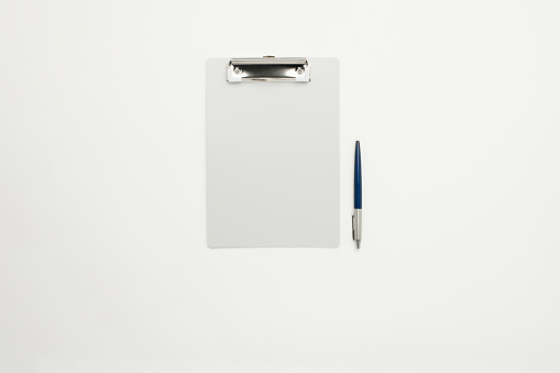 Light grey clipboard and a pencil background for design use