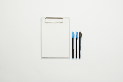 Office supplies flat lay - Clipboard with writing materials