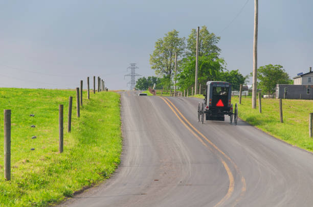 Amish Buggy Approaching Hill in rural Indiana.