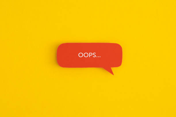 Paper speech bubble with the word "OOPS" on a yellow background. Top view with copy space. Flat lay. Paper speech bubble with the word "OOPS" on a yellow background. Top view with copy space. Flat lay. error message stock pictures, royalty-free photos & images