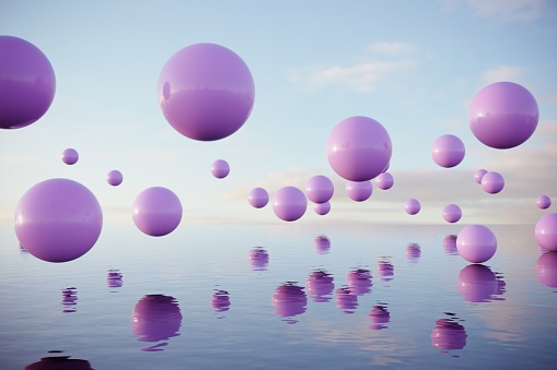 Pink colored balls flying above the reflective water . (3d render)