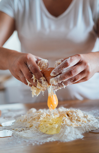 Woman’s hands kneading dough on a counter top
