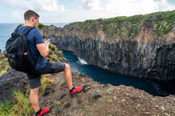 человек на краю скалы вулкана, терсейра, азорские острова - hiking coastline waters edge sunny стоковые фото и изображения