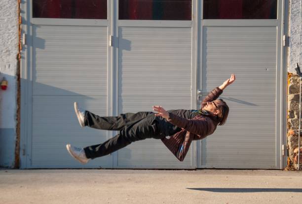 istock Man in mid-air with a gray gate on the background 1481194886