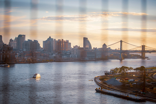 Views of Downtown Brooklyn featuring the East River, Manhattan Bridge, and Brooklyn Bridge from the Williamsburg Bridge at Sunset