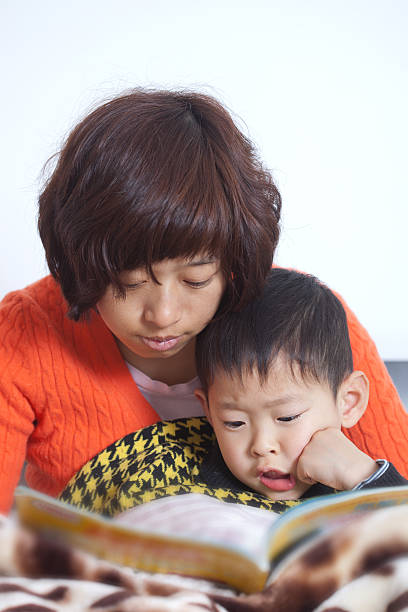 istock mother and boy reading book 148119760