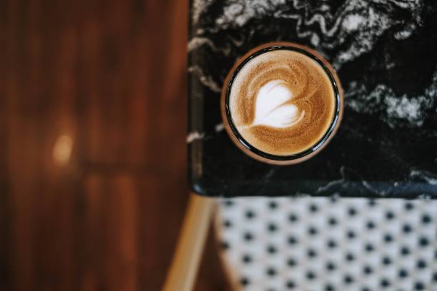 istock A cup of coffee with Latte Art on black marble table 1481197871