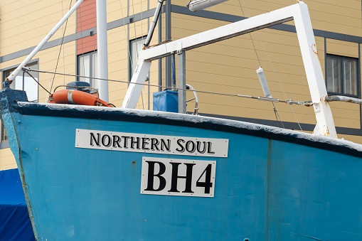Amble, United Kingdom – March 11, 2023: The boat, Northern Soul, on land by the marina in the town of Amble, Northumberland, UK.
