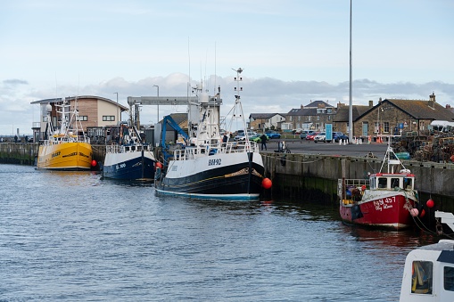 Amble, United Kingdom – March 11, 2023: Boats moored at the harbour in the town of Amble, Northumberland, UK.