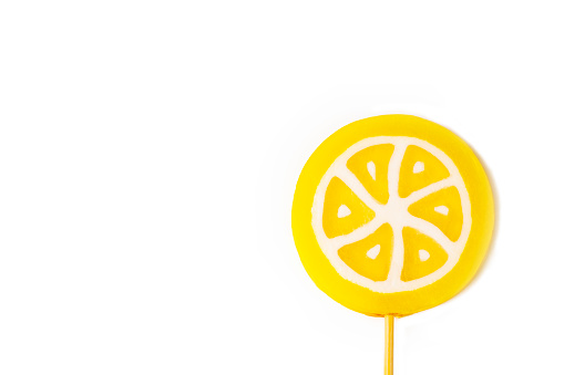 Yellow lollipop candy. Lemon lollipop.