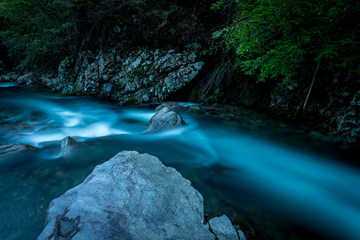 Rapid flow of the river in the mountains of  at dusk.