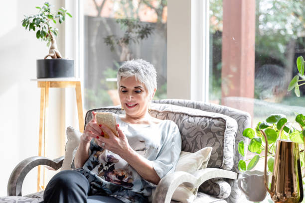 istock Mature woman reads emails before she begins her work day 1481199879