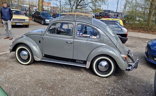 Side view of a cream coloured vintage Morris Minor. The cars were designed in the UK, and produced from 1948 to 1971.