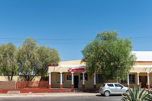 Kenhardt, South Africa - Feb 28 2023: A street scene, with a liquor store, in Kenhardt in the Northern Cape Province. A car is visible