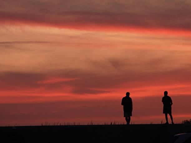 istock Dramatic sunset sky in the Everglades with two people in silhouette 1481215869