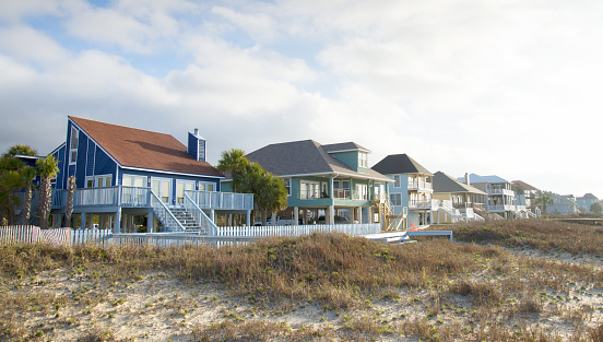 A row of vacation cottages in the sand dunes, Florida, USA.