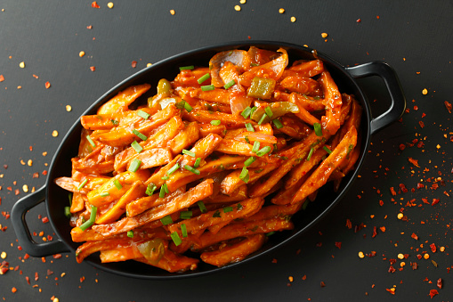 Schezwan potato fries are a popular snack that combine crispy fries with the bold and spicy flavors of Schezwan sauce.