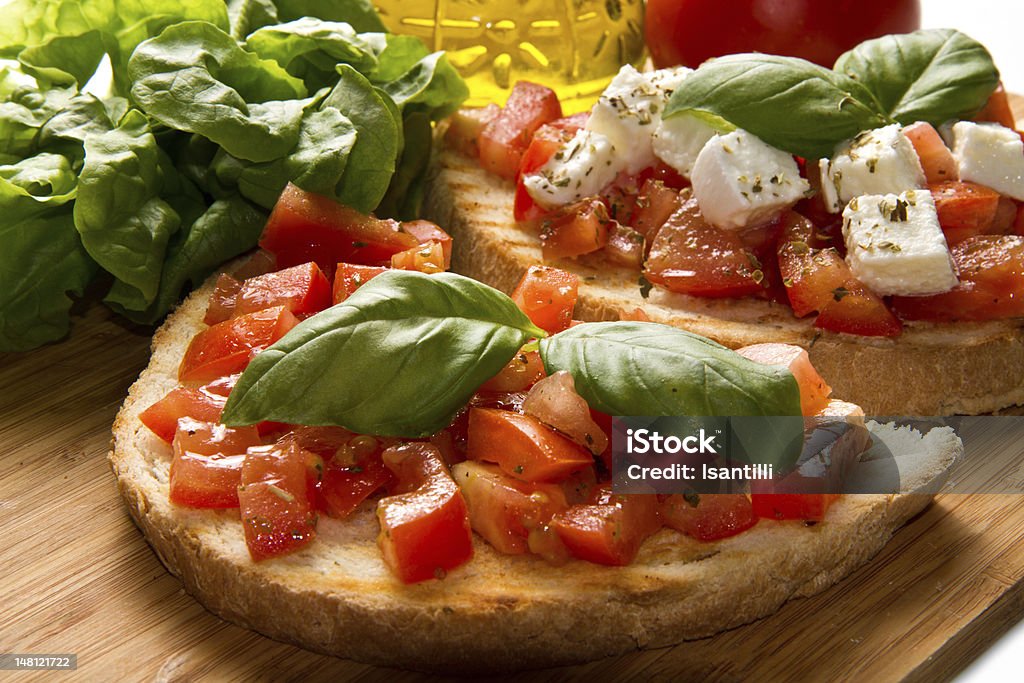 italian bruschetta italian bruschetta with fresh tomatoes, basil, garlic, olive oil and cheese Appetizer Stock Photo