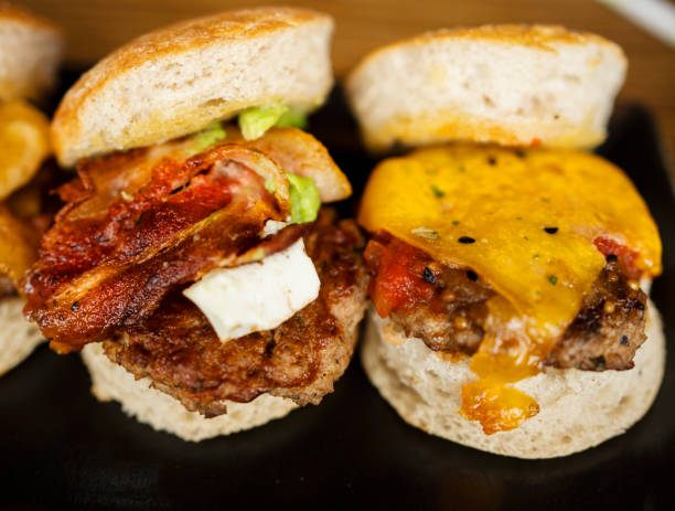 Two freshly-made gourmet burgers sitting on a table