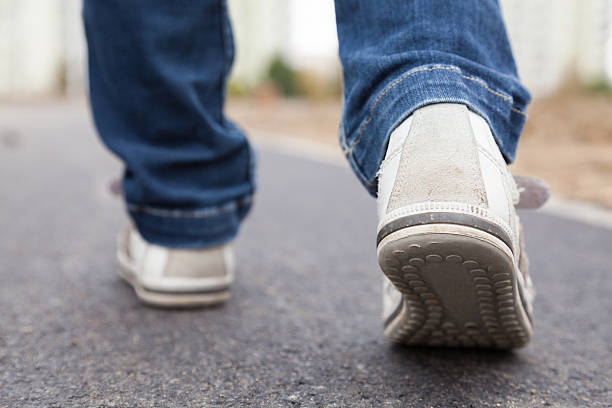 Walking in sport shoes on pavement stock photo