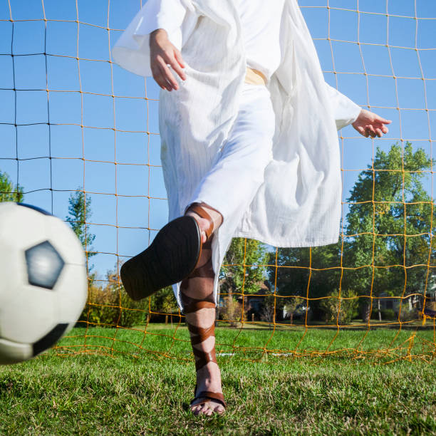 Jesus Playing European Football/Soccer Jesus Christ playing European football (soccer). gladiator shoe stock pictures, royalty-free photos & images