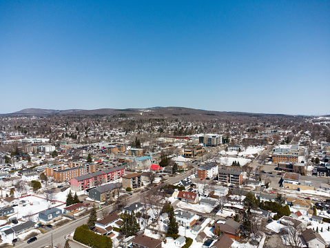 Aerial view of residential area in Quebec city suburbs during day of winter.