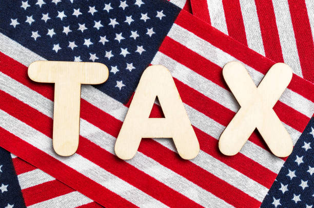 istock Word TAX with american flags. Close up. 1481220231