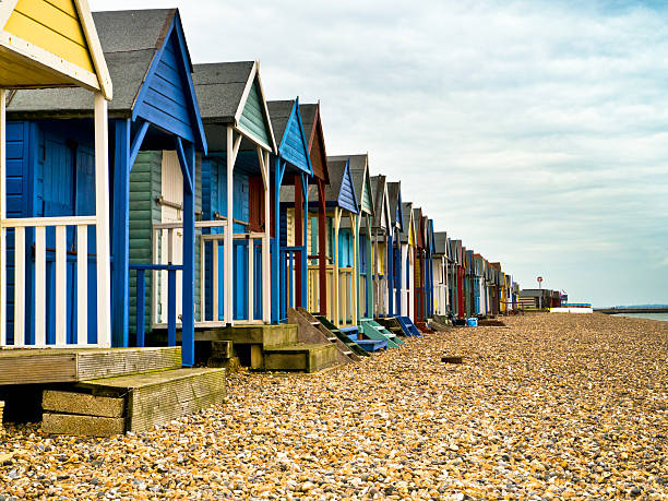 Beach Huts Beach Huts along a pebble beach in Kent. herne bay stock pictures, royalty-free photos & images