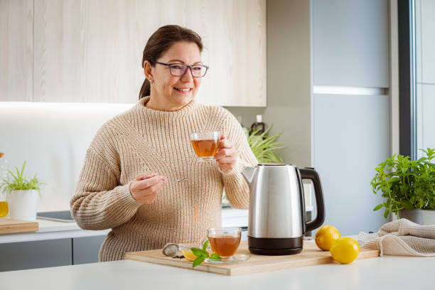 istock Woman drinking hot tea in kitchen 1481221370