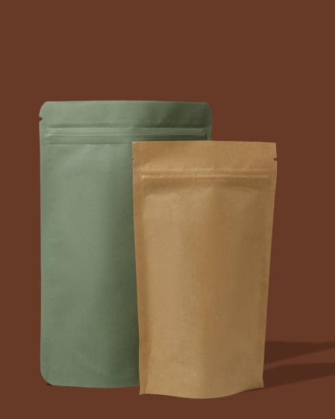 istock Green and brown cardboard packaging for tea. Branding and packaging mockup for tea, coffee, snacks on a brown background 1481221423