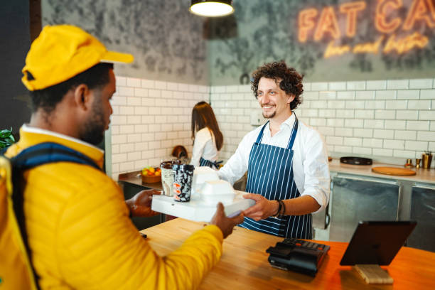 istock Black delivery man picking up customers order at the bar 1481221737