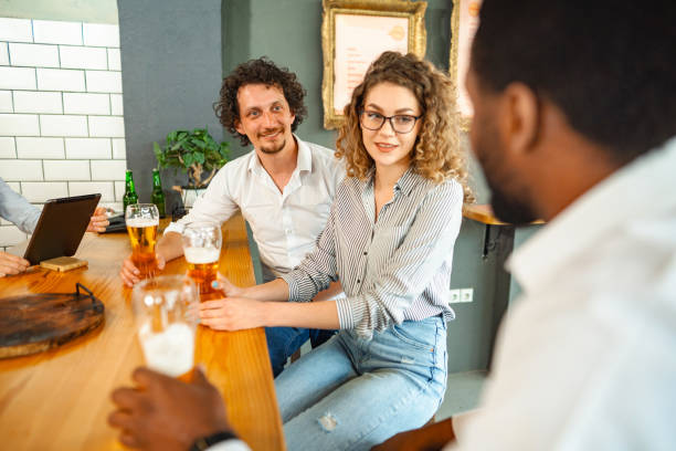 istock Multiracial friends having fun while talking and drinking beer at a bar 1481221796