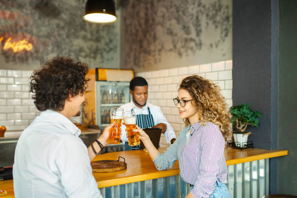 istock Lovely couple having fun while toasting with beer at a bar 1481221802