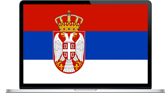 Serbian flag waving on a green background. Horizontal composition with copy space.