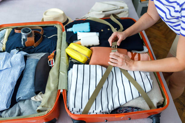 istock Young woman packing suitcase for travel 1481222484