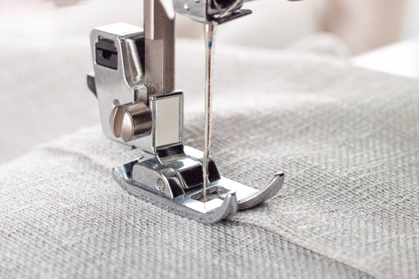 istock Modern sewing machine presser foot with linen fabric and thread, closeup 1481223002