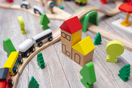 Close-up of the colorful kids toy town with a railroad. Wooden toys